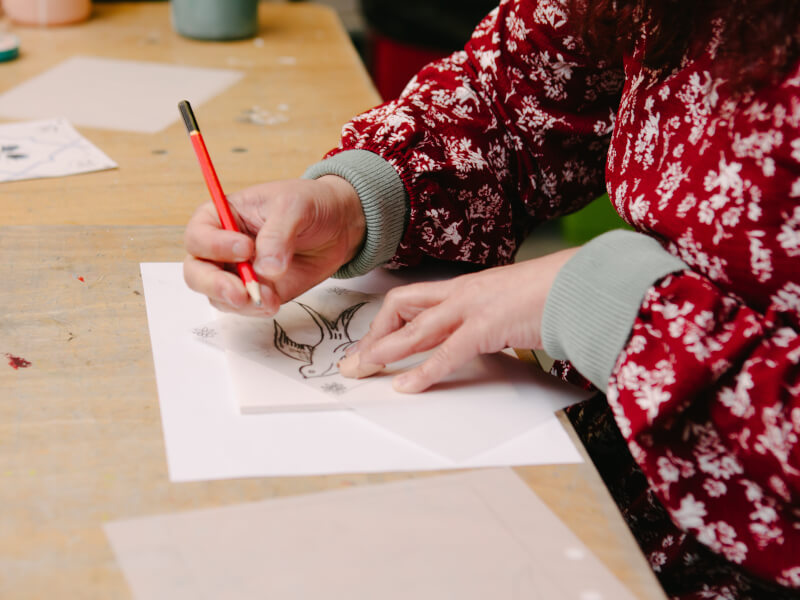Hands using a pencil in a drawing class
